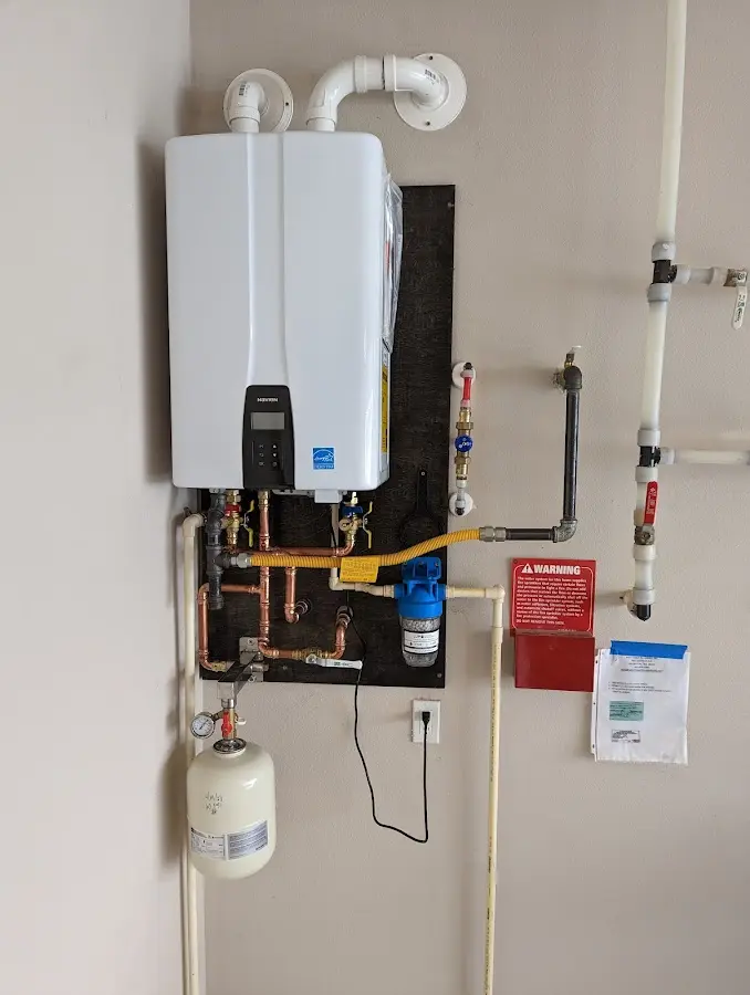 Professional plumber installing copper piping in a Shorewood home